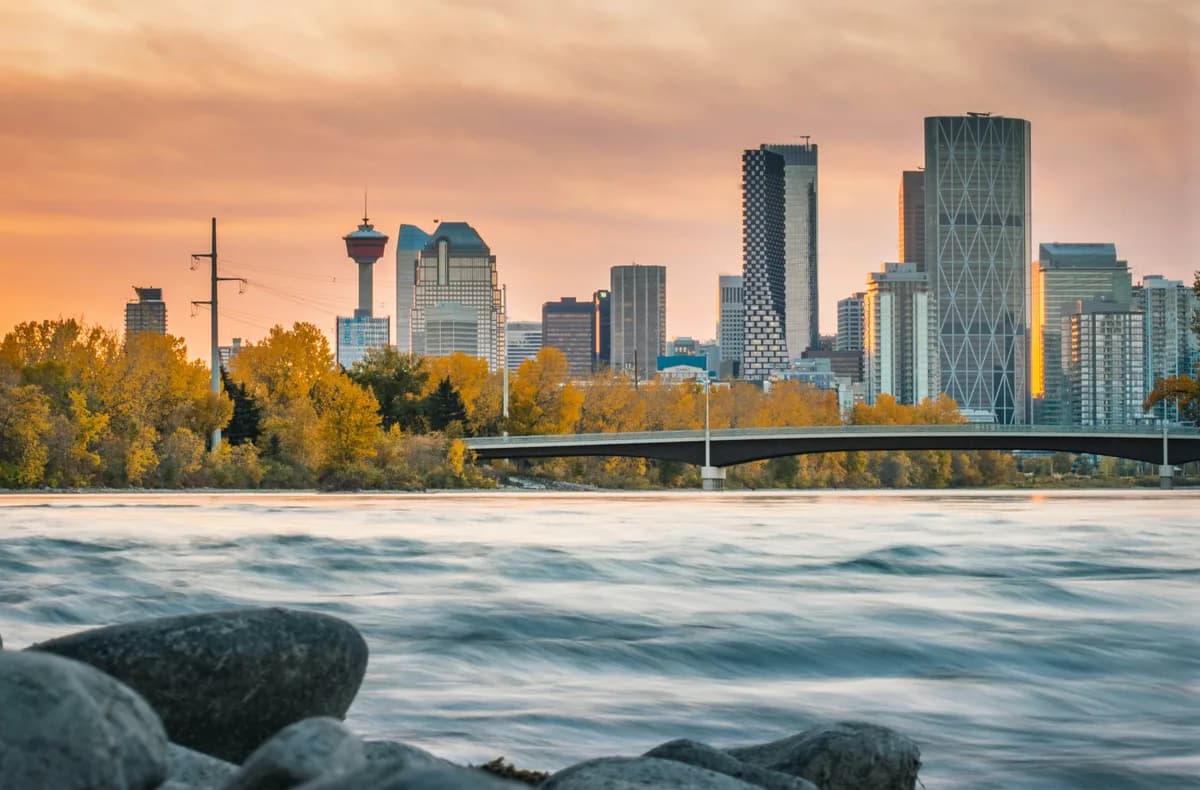 Bow River valley with Calgary skyline beyond nearby inner-city neighbourhoods