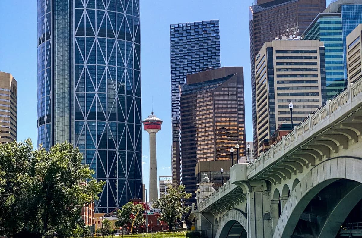 Bow River and downtown Calgary towers beside an inner-city bridge