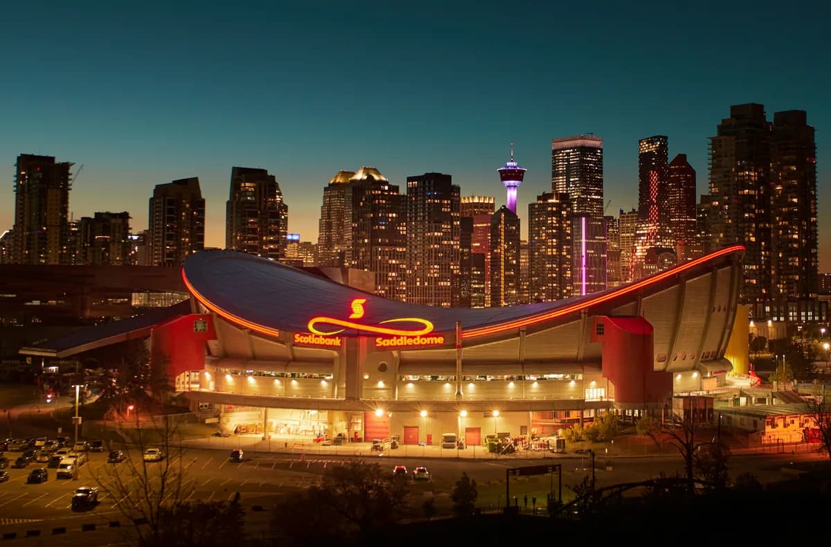 Calgary skyline and Saddledome lit against the evening sky